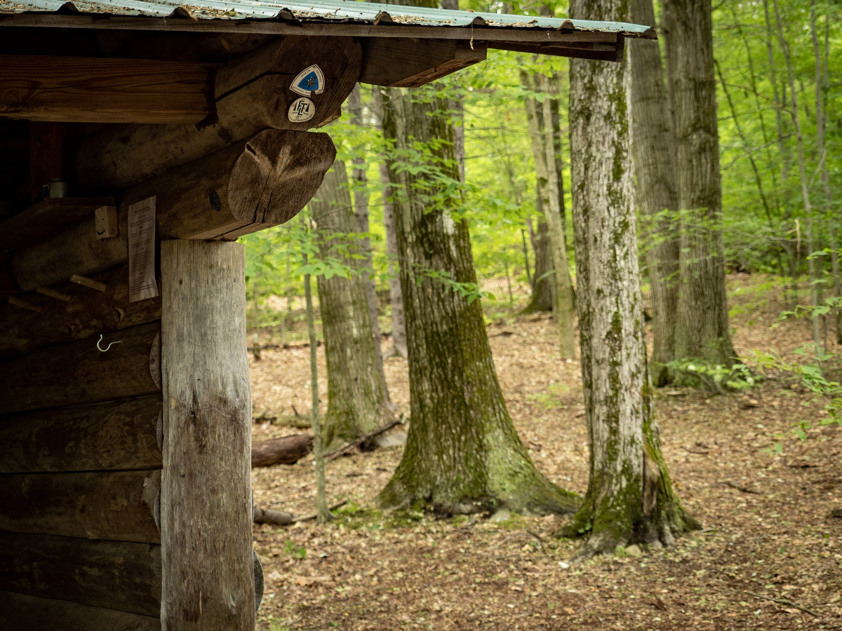 The corner of a lean-to showing Finger Lakes Trail and North Country Trail signs