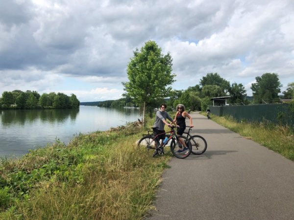 Bikers on along the trail with Cayuga Inlet in background