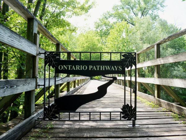 A wooden bridge with a metal gate