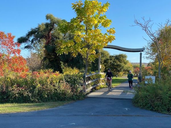 A person on a bike on a paved trail