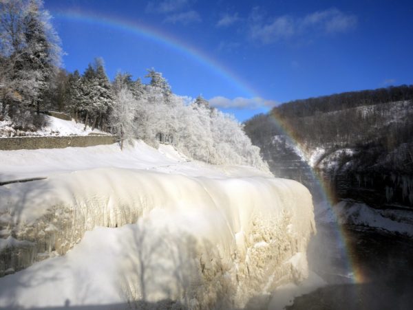 An ice-crusted gorge framed with a rainbow