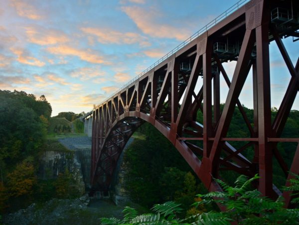 A red metal railroad bridge