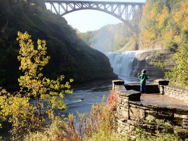 A railroad bridge above a waterfall