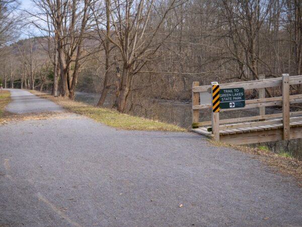 A path with a bridge that crosses a canal