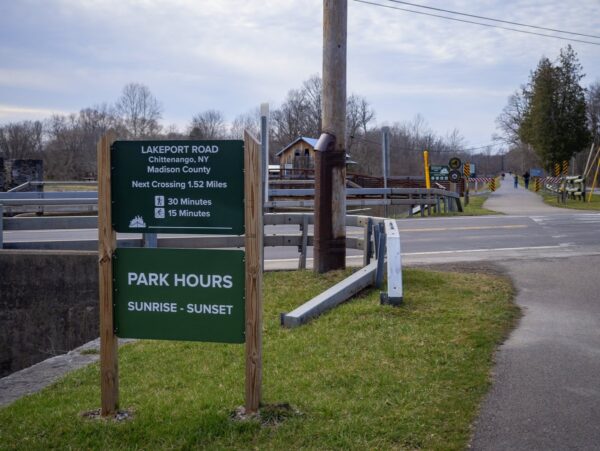 A sign on a trail indicting distance to nearby locations