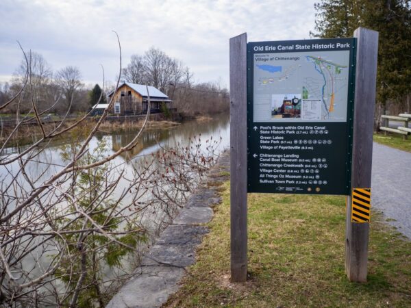 A trail sign with a map and other info