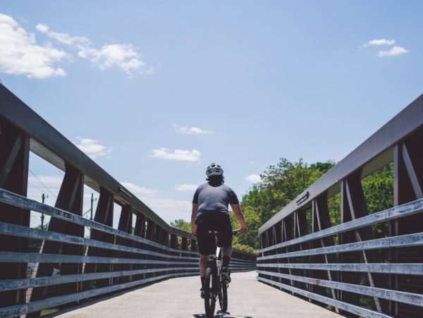 A person biking on a bridge