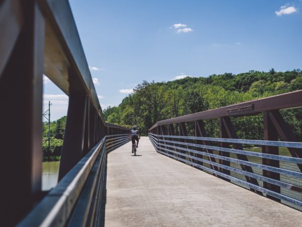 A person on a bike crossing a bridge