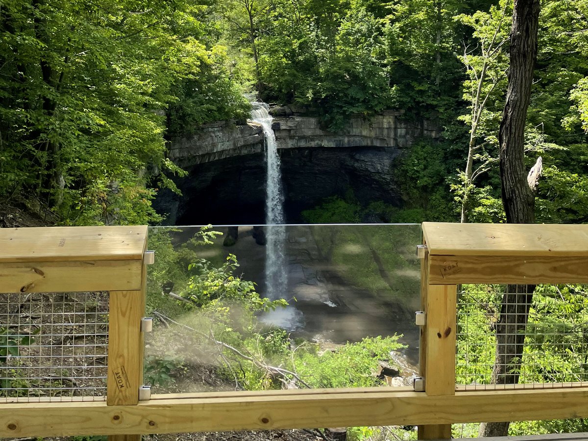 A view of a waterfall from a wooden viewing platform