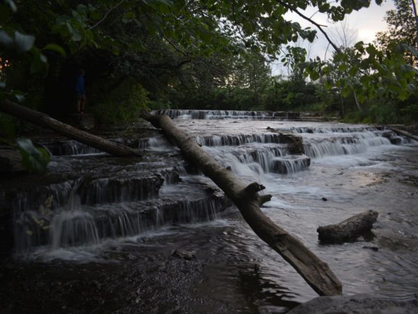 A small waterfall and fallen log