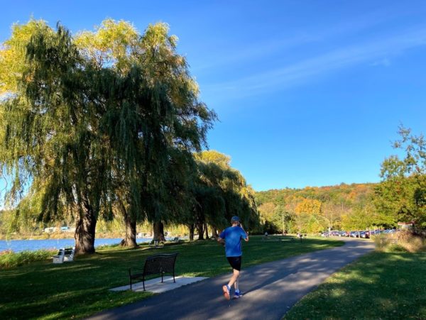 A person running on a paved trail