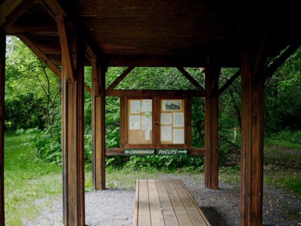 A wooden kiosk with trail information