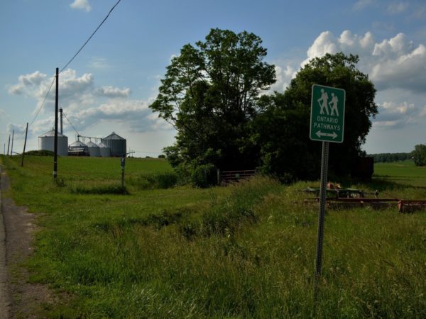 An entry sign and open field