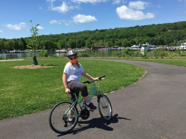 A person on a bike on a paved trail