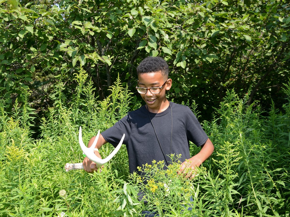 A boy with a deer shed