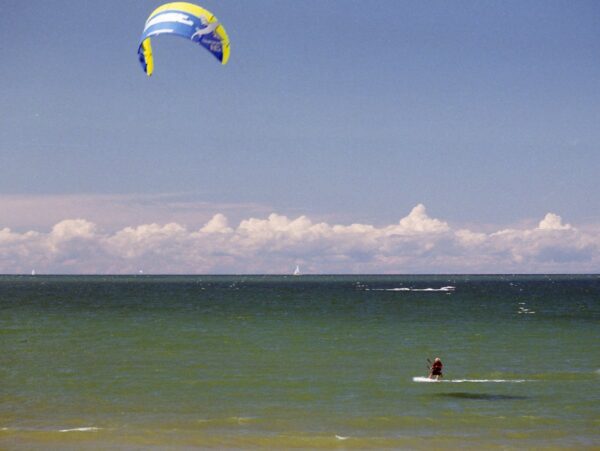 A person kite surfing on a windy lake